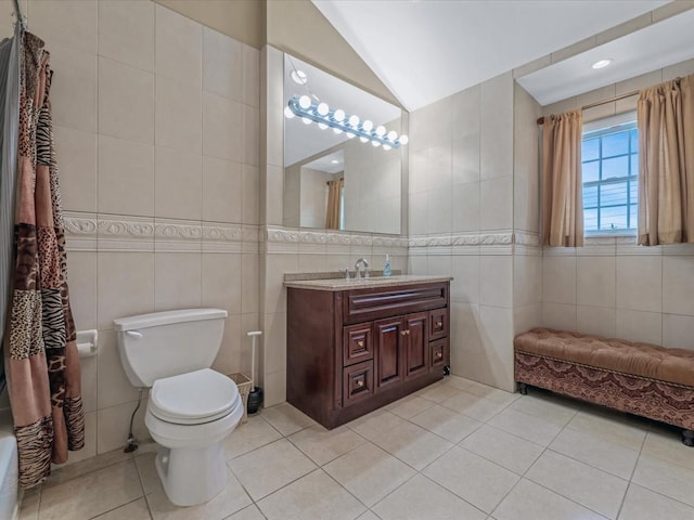 1674 Birch Dr, Merrick, NY 11566 - full bath with tile walls, tile patterned floors, lofted ceiling, vanity, and toilet