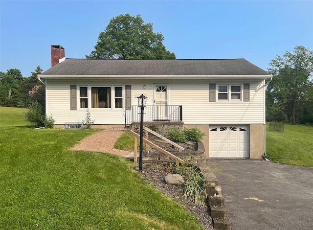74 E Ridge Rd, Warwick, NY 10990 - ranch-style house with a chimney, asphalt driveway, an attached garage, and a front lawn