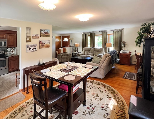 74 E Ridge Rd, Warwick, NY 10990 - dining area with light wood-type flooring and a baseboard radiator