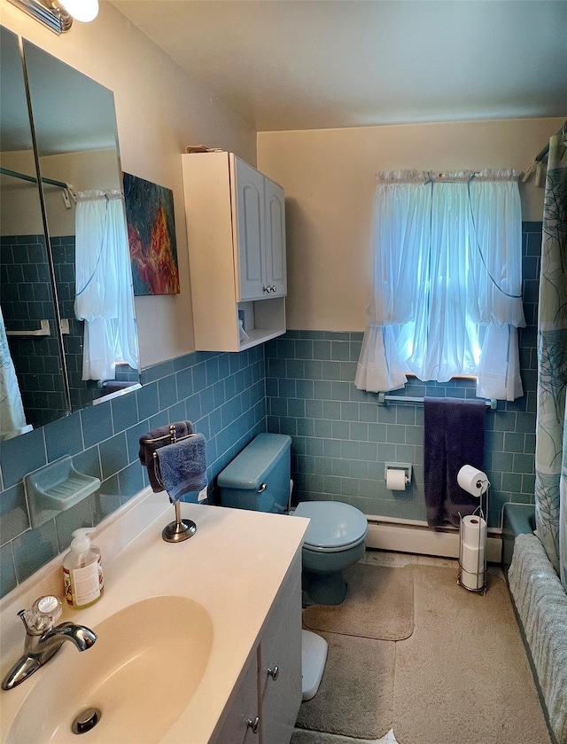 74 E Ridge Rd, Warwick, NY 10990 - bathroom featuring tile walls, toilet, vanity, a baseboard heating unit, and wainscoting