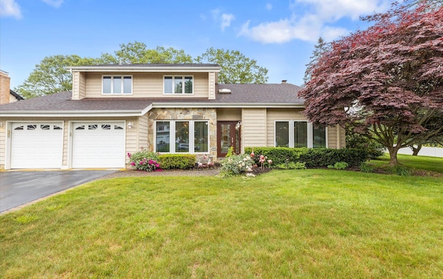 34 Oak Meadow Rd, Commack, NY 11725 - view of front of house with asphalt driveway, a front yard, a shingled roof, and an attached garage