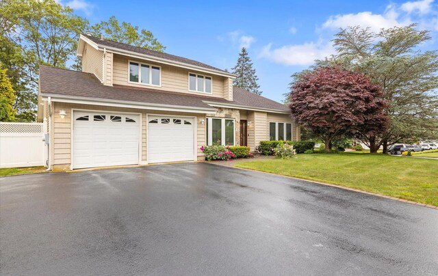 34 Oak Meadow Rd, Commack, NY 11725 - view of front facade featuring driveway, an attached garage, and a shingled roof