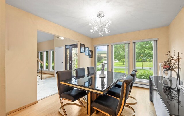 34 Oak Meadow Rd, Commack, NY 11725 - dining room with a chandelier, light wood finished floors, and baseboard heating