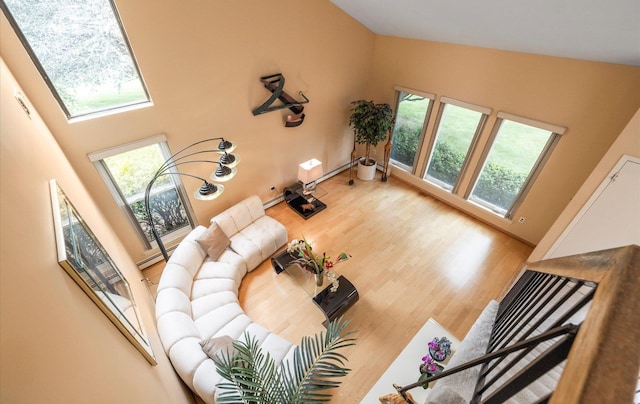 34 Oak Meadow Rd, Commack, NY 11725 - living room with plenty of natural light, wood finished floors, and high vaulted ceiling