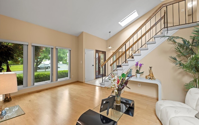 34 Oak Meadow Rd, Commack, NY 11725 - entryway with stairs, wood finished floors, a skylight, and high vaulted ceiling