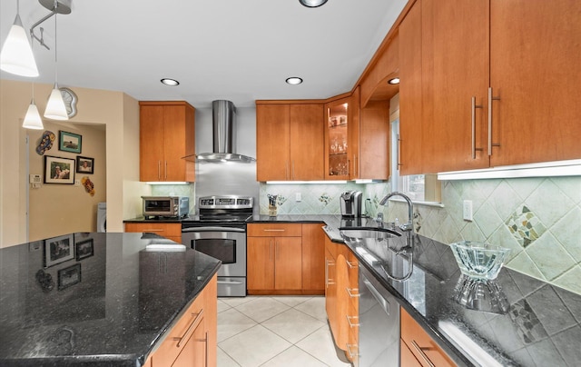 34 Oak Meadow Rd, Commack, NY 11725 - kitchen with wall chimney exhaust hood, appliances with stainless steel finishes, brown cabinetry, dark stone countertops, and glass insert cabinets