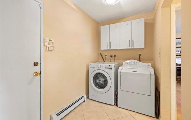 34 Oak Meadow Rd, Commack, NY 11725 - laundry room featuring a baseboard heating unit, washing machine and dryer, light tile patterned floors, and cabinet space