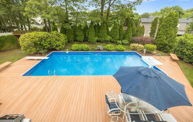 34 Oak Meadow Rd, Commack, NY 11725 - outdoor pool with a wooden deck, view of wooded area, and a diving board