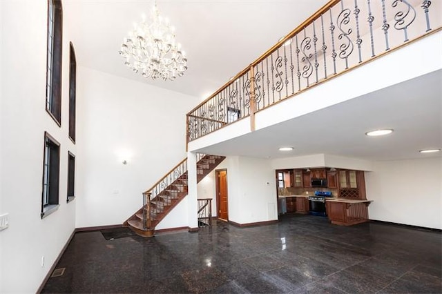 63-39 136th St, Flushing, NY 11367 - unfurnished living room featuring stairway, a towering ceiling, a chandelier, granite floors, and recessed lighting