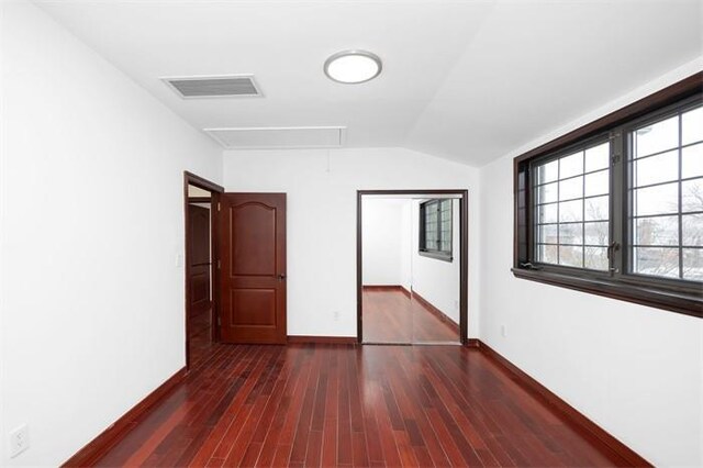 63-39 136th St, Flushing, NY 11367 - unfurnished bedroom featuring attic access, dark wood-style floors, and lofted ceiling