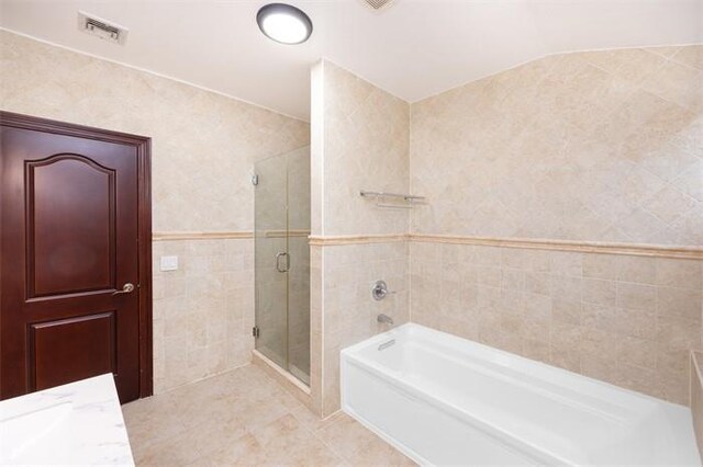 63-39 136th St, Flushing, NY 11367 - full bath with a stall shower, a bath, tile walls, tile patterned floors, and vanity