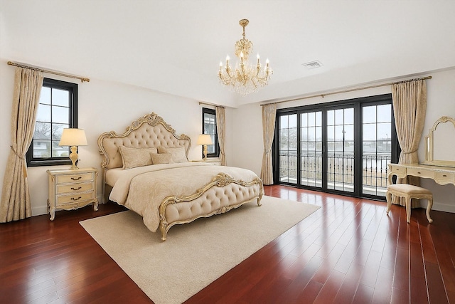 63-39 136th St, Flushing, NY 11367 - bedroom with a chandelier, access to exterior, and dark wood-style flooring