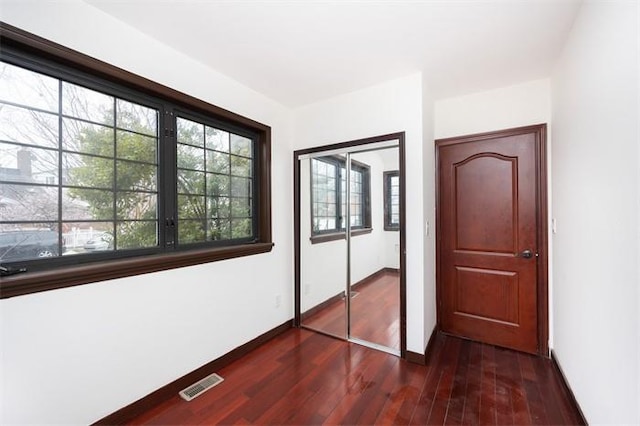 63-39 136th St, Flushing, NY 11367 - unfurnished bedroom featuring dark wood-style floors and a closet