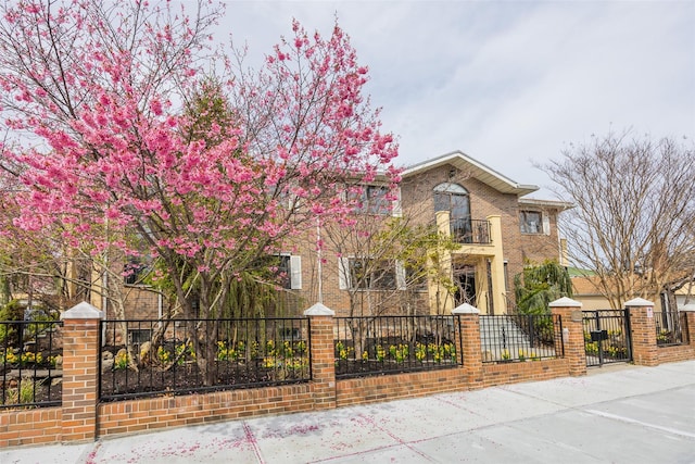 63-39 136th St, Flushing, NY 11367 - view of front of property featuring a fenced front yard, a gate, brick siding, and a balcony