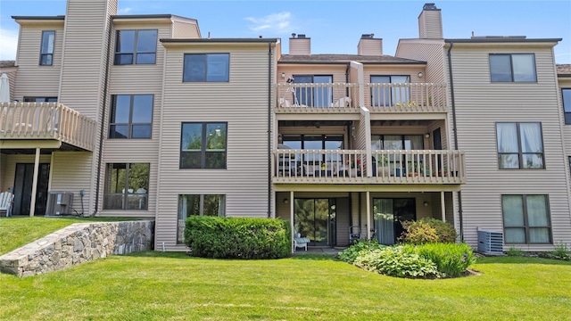 4 Hudson Watch Dr Unit 4, Ossining, NY 10562 - back of house with a balcony, a chimney, and a lawn