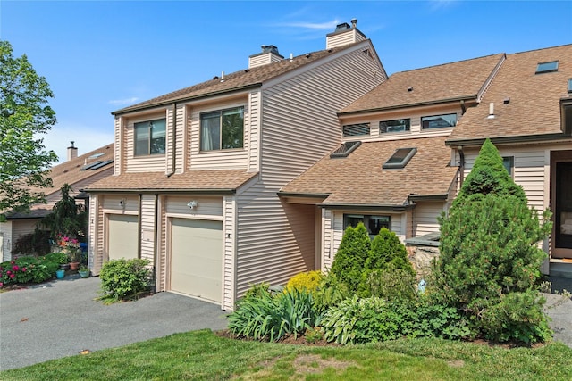 4 Hudson Watch Dr Unit 4, Ossining, NY 10562 - view of property with a chimney, asphalt driveway, a garage, and a shingled roof