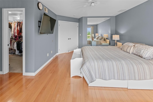 4 Hudson Watch Dr Unit 4, Ossining, NY 10562 - bedroom featuring a walk in closet, light wood-type flooring, and a closet