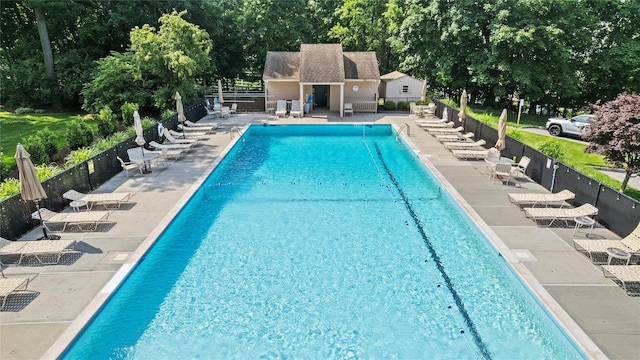 4 Hudson Watch Dr Unit 4, Ossining, NY 10562 - community pool featuring a patio, an outbuilding, and view of wooded area