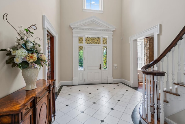 7 Fox Meadow Ln, Lloyd Harbor, NY 11743 - foyer featuring a towering ceiling, stairway, and light tile patterned floors