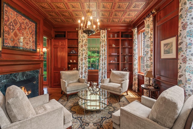 7 Fox Meadow Ln, Lloyd Harbor, NY 11743 - living area featuring ornamental molding, an ornate ceiling, a premium fireplace, wood finished floors, and a chandelier