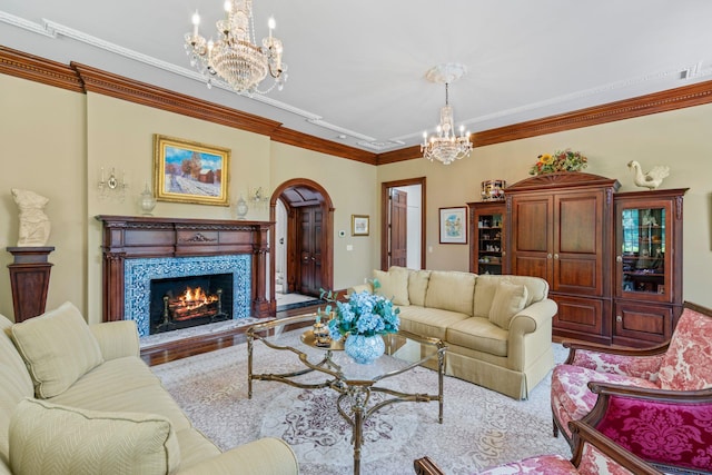 7 Fox Meadow Ln, Lloyd Harbor, NY 11743 - living room featuring a chandelier, ornamental molding, arched walkways, and a fireplace