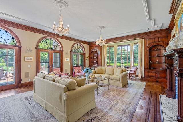 7 Fox Meadow Ln, Lloyd Harbor, NY 11743 - living room with a chandelier, ornamental molding, and built in shelves