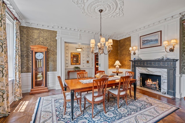 7 Fox Meadow Ln, Lloyd Harbor, NY 11743 - dining area with a decorative wall, crown molding, a chandelier, wainscoting, and a high end fireplace