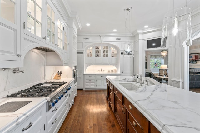 7 Fox Meadow Ln, Lloyd Harbor, NY 11743 - kitchen with stainless steel gas cooktop, white cabinetry, glass insert cabinets, ornamental molding, and dark wood-type flooring