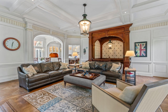 7 Fox Meadow Ln, Lloyd Harbor, NY 11743 - living room featuring a decorative wall, coffered ceiling, arched walkways, and ornamental molding