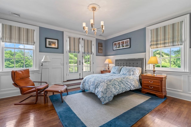 7 Fox Meadow Ln, Lloyd Harbor, NY 11743 - bedroom with a chandelier, multiple windows, a decorative wall, access to exterior, and ornamental molding