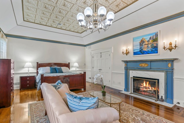 7 Fox Meadow Ln, Lloyd Harbor, NY 11743 - bedroom with wood finished floors, a chandelier, an ornate ceiling, a fireplace, and a closet