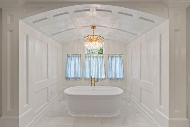 7 Fox Meadow Ln, Lloyd Harbor, NY 11743 - bathroom featuring a freestanding tub, a chandelier, lofted ceiling, and marble finish floors
