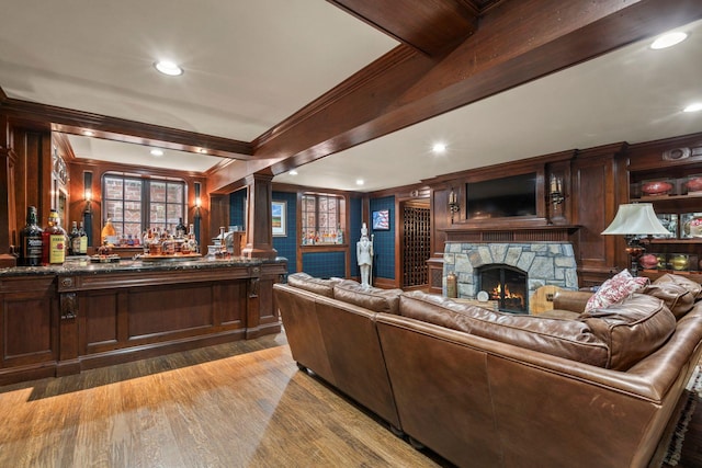 7 Fox Meadow Ln, Lloyd Harbor, NY 11743 - living room featuring crown molding, a bar, light wood-type flooring, a stone fireplace, and recessed lighting