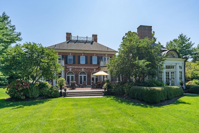 7 Fox Meadow Ln, Lloyd Harbor, NY 11743 - rear view of house featuring french doors, a lawn, and a patio area
