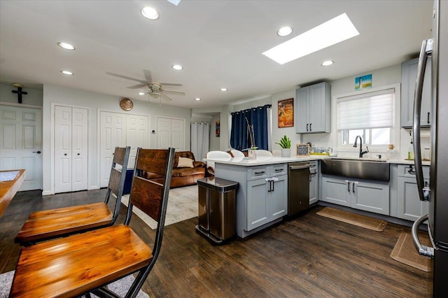 146 First St, Yonkers, NY 10704 - kitchen with a peninsula, stainless steel appliances, a skylight, a sink, and recessed lighting