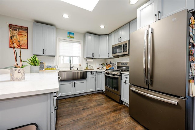 146 First St, Yonkers, NY 10704 - kitchen with appliances with stainless steel finishes, light countertops, a sink, recessed lighting, and dark wood-type flooring