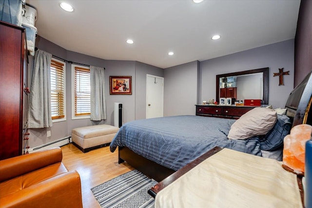 146 First St, Yonkers, NY 10704 - bedroom featuring a baseboard radiator, wood finished floors, and recessed lighting