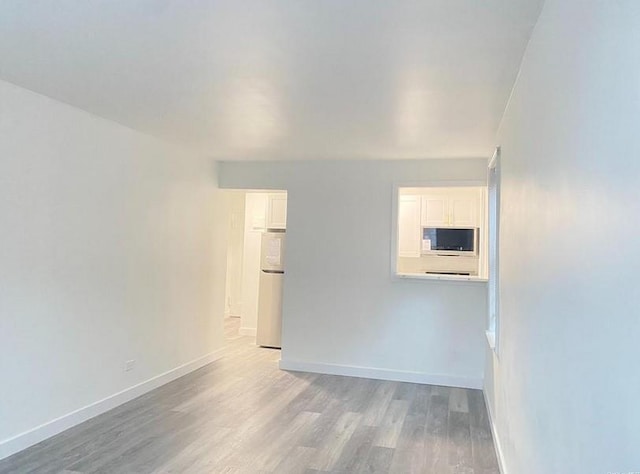 150-29 72nd Rd Unit 5E, Kew Garden Hills, NY 11367 - spare room with light wood finished floors and baseboards