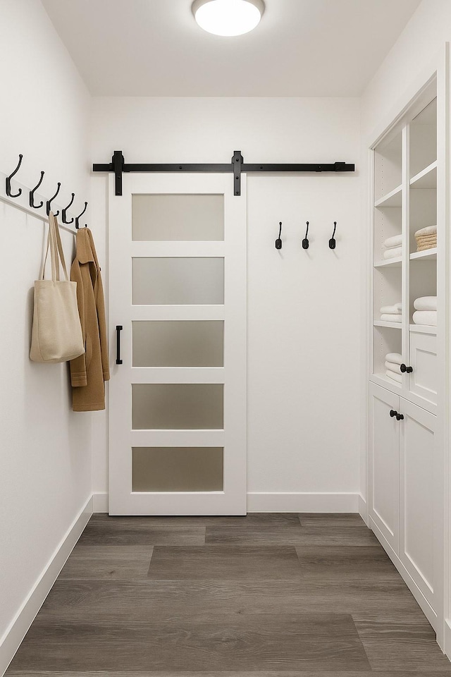 150-29 72nd Rd Unit 5E, Kew Garden Hills, NY 11367 - mudroom featuring a barn door, baseboards, and dark wood-type flooring