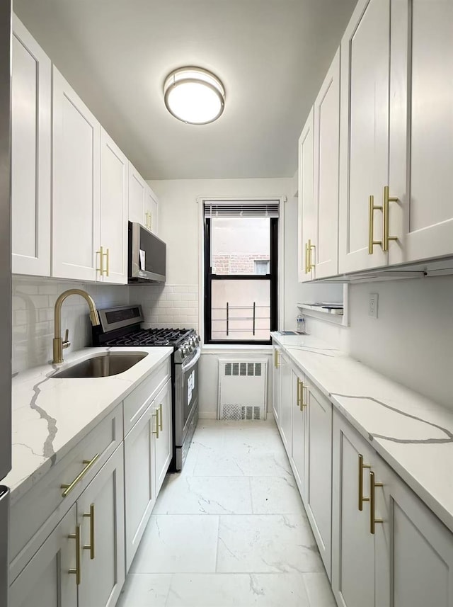 150-29 72nd Rd Unit 5E, Kew Garden Hills, NY 11367 - kitchen featuring radiator, appliances with stainless steel finishes, light marble finish floors, a sink, and light stone countertops