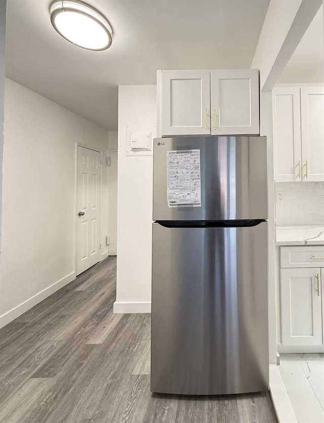 150-29 72nd Rd Unit 5E, Kew Garden Hills, NY 11367 - kitchen with freestanding refrigerator, light wood finished floors, white cabinetry, and backsplash