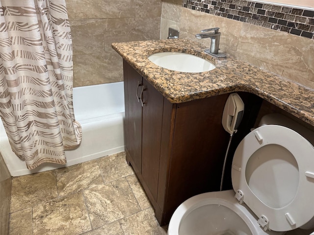 61-55 98th St Unit 14L, Rego Park, NY 11374 - full bathroom with shower / bath combo with shower curtain, toilet, vanity, stone finish floors, and backsplash