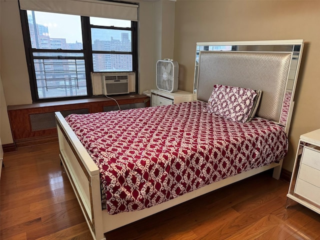 61-55 98th St Unit 14L, Rego Park, NY 11374 - bedroom with wood finished floors, cooling unit, and baseboards