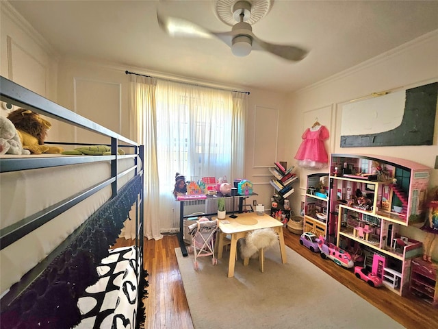 112-25 34th Ave Unit 2D, Corona, NY 11368 - recreation room featuring a ceiling fan, wood finished floors, and ornamental molding