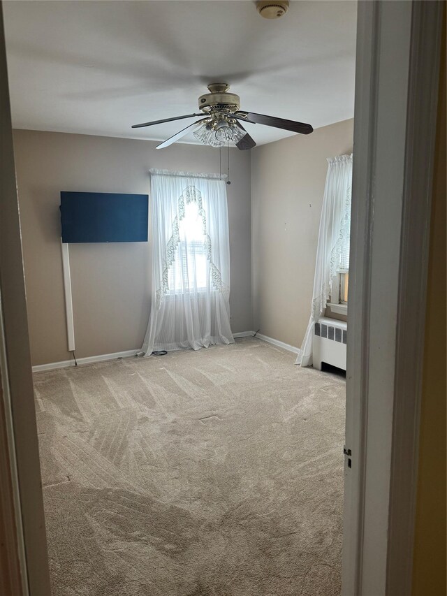 92 Lincoln Blvd, Hauppauge, NY 11788 - carpeted empty room featuring a ceiling fan and radiator