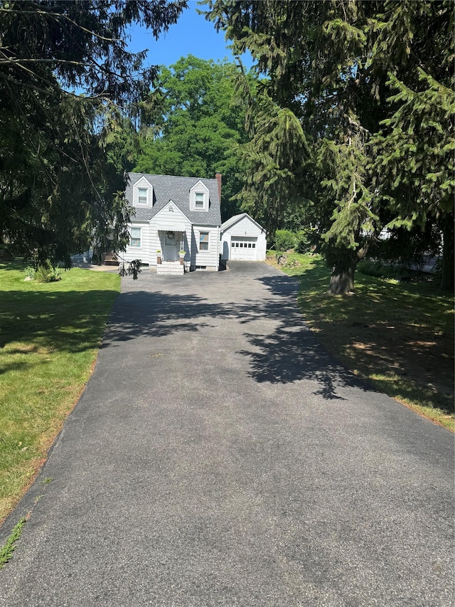 92 Lincoln Blvd, Hauppauge, NY 11788 - cape cod-style house featuring a front lawn, a detached garage, and a chimney