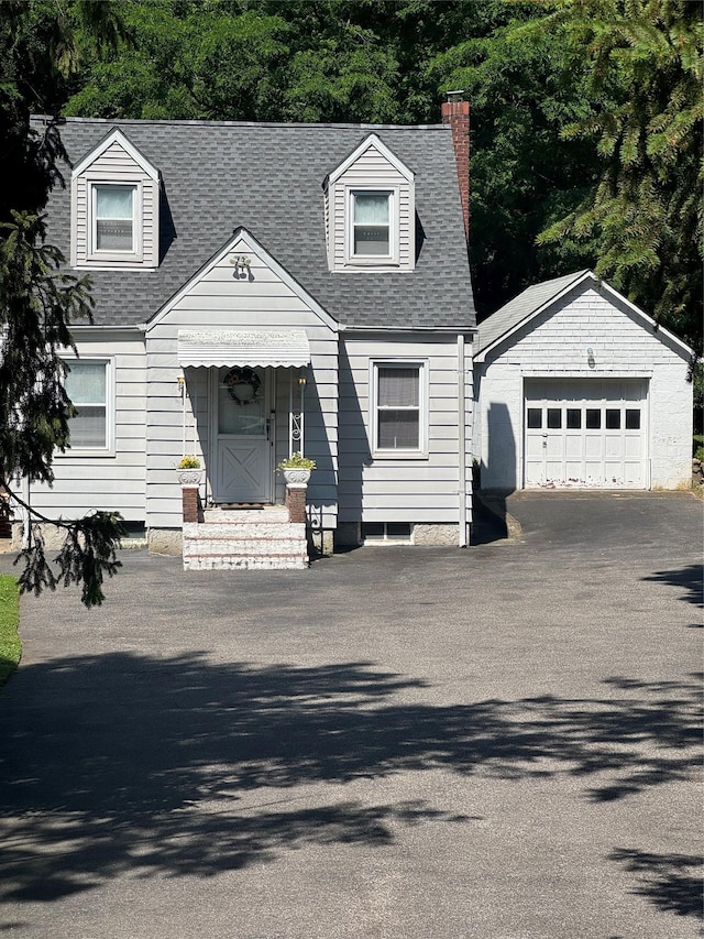 92 Lincoln Blvd, Hauppauge, NY 11788 - cape cod-style house with a chimney, an outbuilding, driveway, entry steps, and a garage