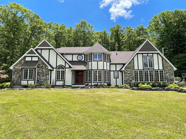 71 Saddleback Ridge Rd, Wallkill, NY 12589 - tudor home featuring stone siding, stucco siding, a front yard, and roof with shingles