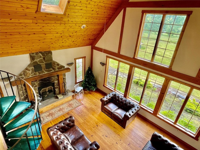 71 Saddleback Ridge Rd, Wallkill, NY 12589 - living area featuring high vaulted ceiling, a stone fireplace, a skylight, wood finished floors, and wood ceiling