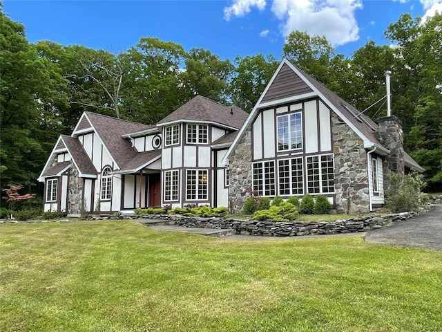 71 Saddleback Ridge Rd, Wallkill, NY 12589 - rear view of property with stone siding, a yard, a shingled roof, and stucco siding